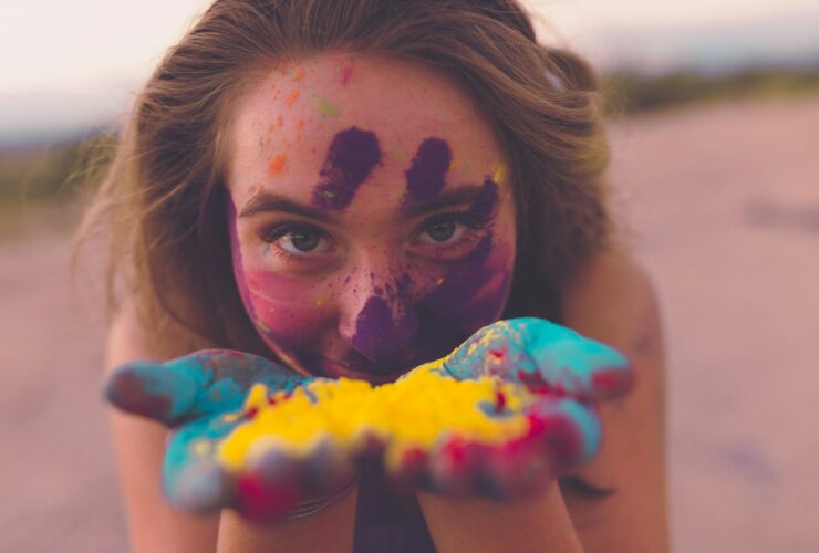 woman with coloring powders on face and hand