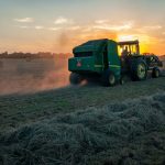 green farm heavy equipment on green field