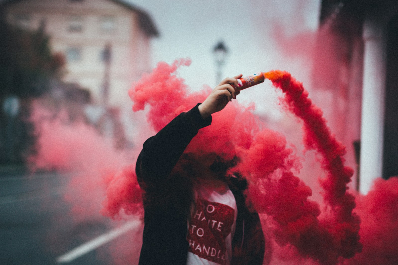 person holding canister with smoke